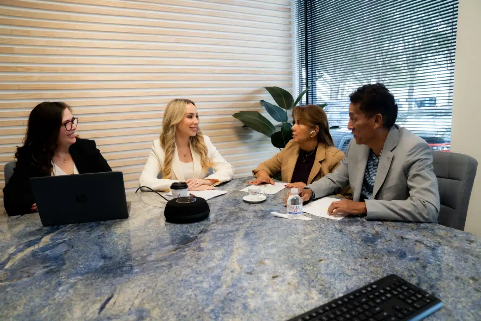 Attorney meeting with a couple to discuss their case in a law office conference room